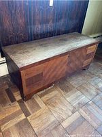 Front and side view of wooden Lane cedar chest showing wood grain and front lock.