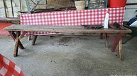 Full side view of wood picnic table showing length and broken leg detail.