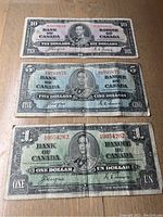 Front side of 1937 Canadian $10, $5, and $1 bills showing King George VI portrait and bilingual text.