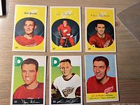 Set of six Detroit Red Wings hockey cards featuring six players with portrait images, names, and team logos.