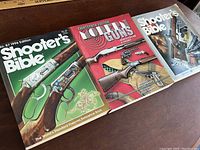 Three firearm reference books laid out showing covers and titles