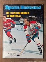 Front cover of 1977 Sports Illustrated magazine featuring Guy Lafleur in hockey gear, in action on ice.