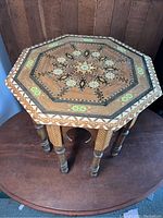 Top view of the octagonal side table showing intricate geometric inlay design and decorative border details.