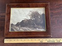 Framed black and white print with ruler for scale, showing size and condition of the piece.