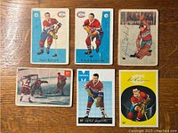 Front view of six Montreal Canadiens hockey cards featuring Henri Richard, Ralph Backstrom, Gerry McNeil, Jacques Plante rookie, Phillippe Goyette, and Robert Rousseau.