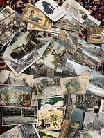 Overhead view of assorted postcards on rug showing a mix of black-and-white and color images