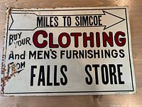 Full front view of the vintage tin sign showing overall lettering and condition.