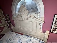 Victorian-style wooden headboard with intricate carved decorative details and cream paint finish, suitable for double bed.