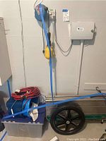 FoldIt utility wagon, plastic storage bin with lid, blue bucket, and coiled red extension cord