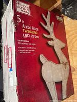 Photo of the box showing the front packaging for a 5 ft Arctic Gaze Twinkling LED 2D Deer by Home Accents Holiday.
