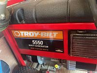 Sticker on generator reading 'Troy-Bilt 5550 Watt Generator 8550 Starting Watts'.