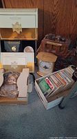 Wide shot showing Downton Abbey collector's materials, ceramic stagecoach, clock, doll in box, and View-Master reels box on floor