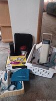 Wide photo showing all items including Ott-Lite lamp, magnifiers, flashlights, and cases.