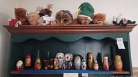 Top shelf stuffed animals including owls, bears, a moose, and Beanie Babies.