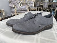 Side view of the grey suede Ecco dress shoes showing the full shoe profile and rubber sole.