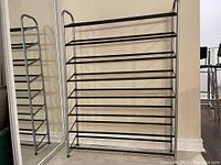 Full view of the assembled metal shoe rack showing 8 horizontal rows for shoe storage.
