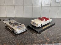 Both model cars together showing the front and side details