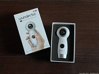 Wunder360 camera in original box showing front side with lens, control button, and branding