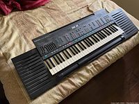 Full view of the Yamaha PSR-4600 electric keyboard showing keys, speaker grills, and overall body condition.