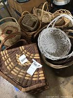 Overview of various woven baskets and large hamper showing size and weave style