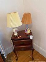 Nightstand with both lamps on top, showing overall furniture and lamps.