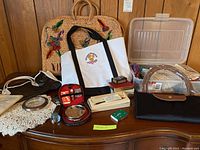 Full lot contents on wooden dresser showing totes, scarves, travel case, magnifying glass and small accessories.