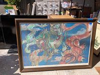 Framed Asian dragon artwork showing two dragons with colorful, detailed designs on a blue background.