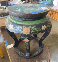 Full view of black painted wood base with scalloped skirt and curved leg supports