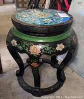 Three-quarter front view showing overall shape, legs, skirt decoration