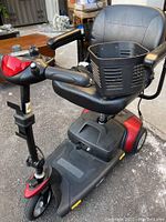 Three-quarter view of entire scooter showing seat, basket, and front wheel.