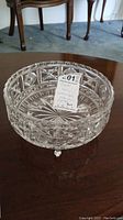 Top and angled views of the detailed cut crystal bowl showing geometric pattern and feet