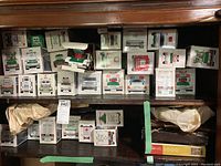 Multiple Hess truck boxes stacked on wooden shelving, roughly two dozen visible