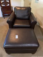 Front view of leather armchair and ottoman