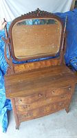 Full view of dresser with attached mirror showing the carved crest and turned side posts.