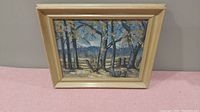 Framed oil painting showing a landscape scene with trees, fence, and mountains, outside frame measures approximately 15x13 inches.