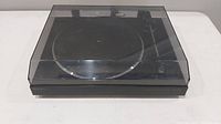 Front view of Sony turntable with transparent dust cover closed, showing overall condition and model shape.