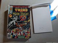 Front cover of Marvel Two-In-One #52 with blank notepad