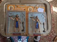 Two Betty Page Cleopatra action figures in blister card packaging showing front view and accessories.