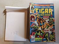 Stack of vintage Marvel comic books with Tigra The Were Woman cover visible on top