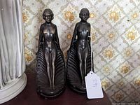 Front view of both Toscano Art Deco bookends showing nude women standing on shells.