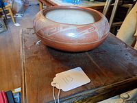 Front three-quarter view of red-on-red bowl showing shape and design band