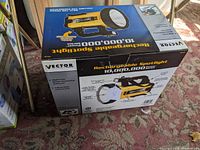 Photo of the Vector rechargeable spotlight flashlight box showing front with product image and features.