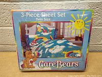 Front view of the sealed Care Bears 3 piece sheet set packaging showing the twin size and colorful bear and rainbow design on the bedding.