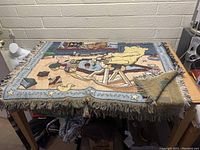 Full view of the Disney Winnie The Pooh woven blanket spread on a table, showing design and fringe edges.