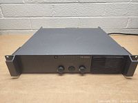 Front view of JBL Synthesis Three Hundred DJ power amplifier showing knobs, power button, LED indicator, and cooling vent.