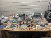 Wide table view showing spread assortment of jewelry and beads on a table.
