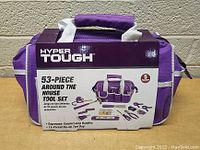 Front view of the purple Hyper Tough tool bag with attached product label describing 53-piece tool set and ergonomic handles.