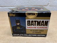 Photo of closed Topps Batman Movie Cards box showing front with Batman image, logo and text indicating 143 glossy cards and 22 stickers