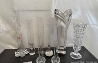 Six vintage crystal items including five vases and one large wing-shaped sculpture displayed against white background.
