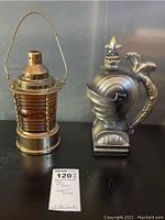 Photo of both lantern and knight helmet music boxes side by side showing their shapes and details